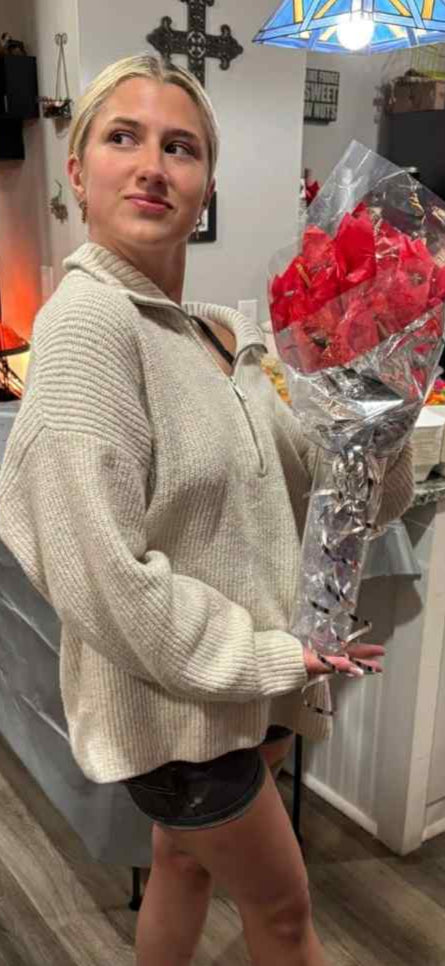 Person holding a bouquet of flowers in a store setting